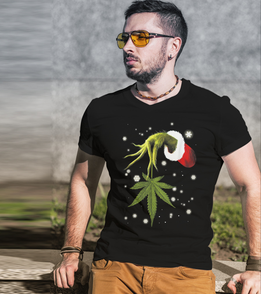 Grinch Hand Holding Cannabis Leaf With Santa Hat And Snowflakes T-Shirt