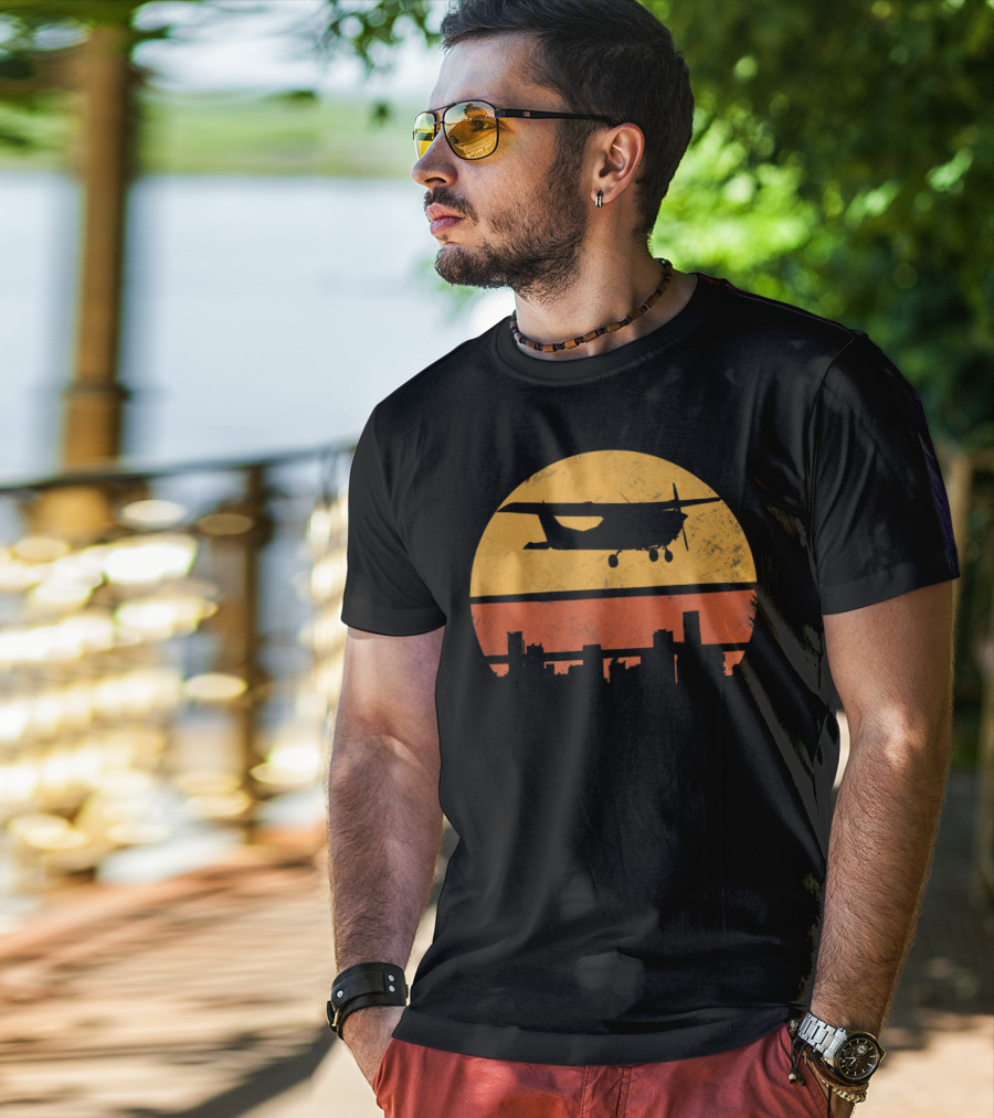 Retro Pilot C172 Flying Silhouette Over Sunset Cityscape T-Shirt
