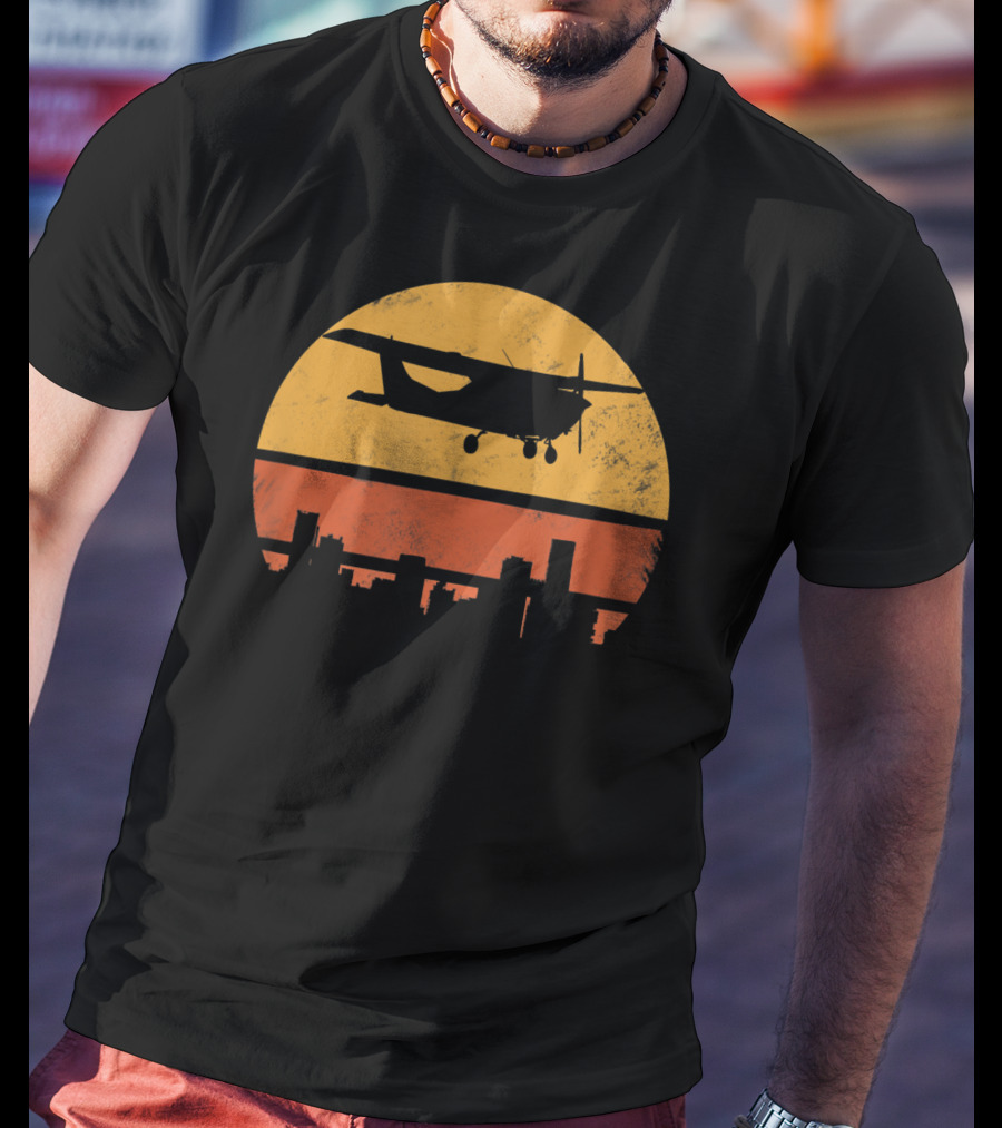 Retro Pilot C172 Flying Silhouette Over Sunset Cityscape T-Shirt