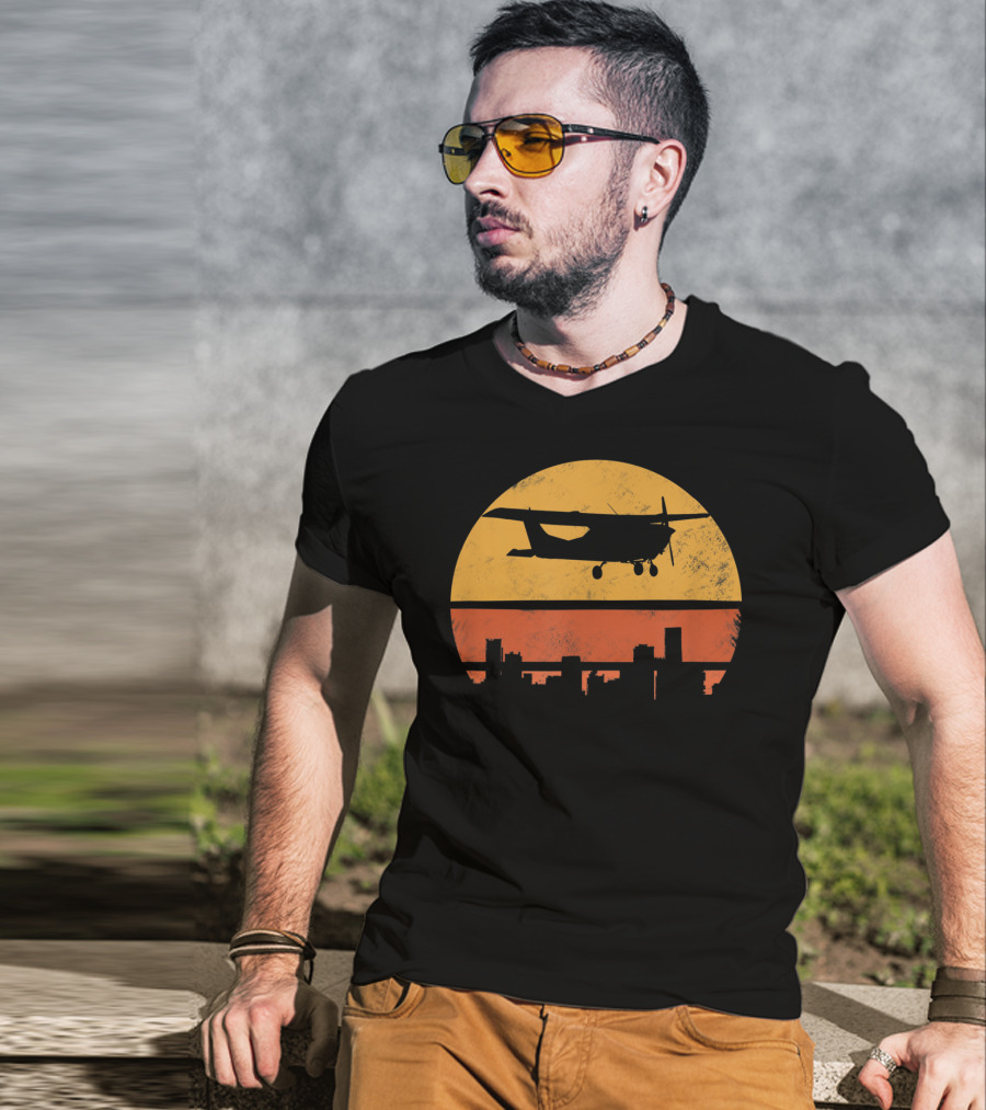Retro Pilot C172 Flying Silhouette Over Sunset Cityscape T-Shirt