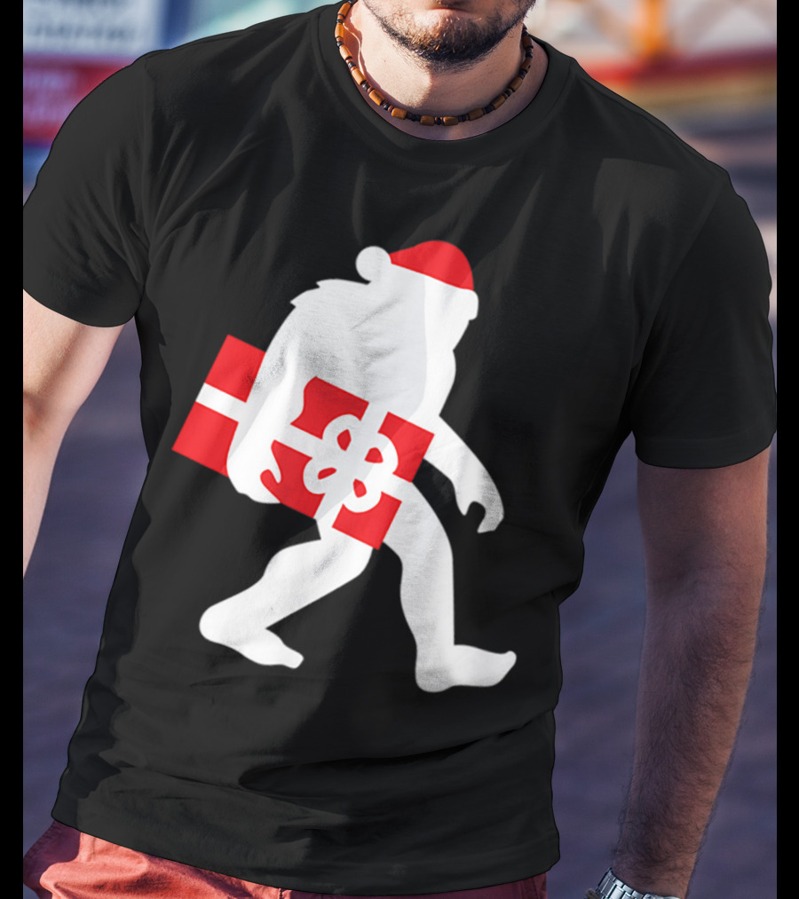 Nice Bigfoot Carrying Christmas Gift In Santa Hat T-Shirt