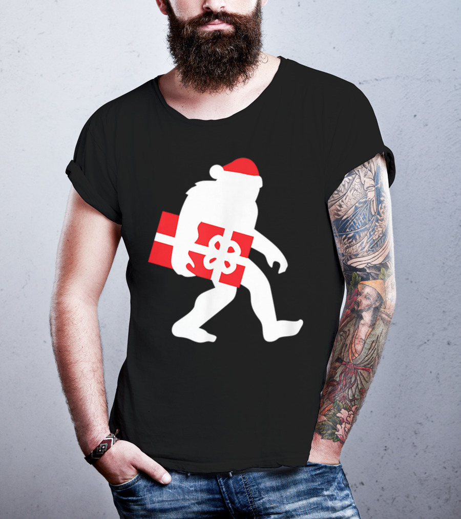 Nice Bigfoot Carrying Christmas Gift In Santa Hat T-Shirt