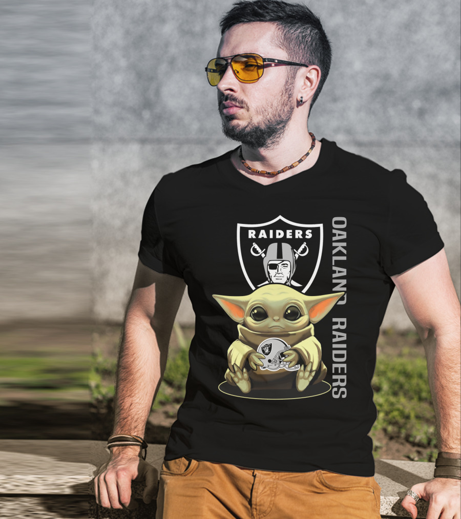 Baby Yoda Holding Oakland Raiders Helmet With Raiders Logo In Background T-Shirt