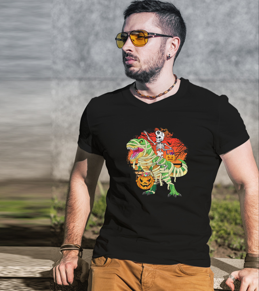 Skeleton Riding Mummy Dinosaur Rex With Halloween Pumpkins On Spooky Background T-Shirt