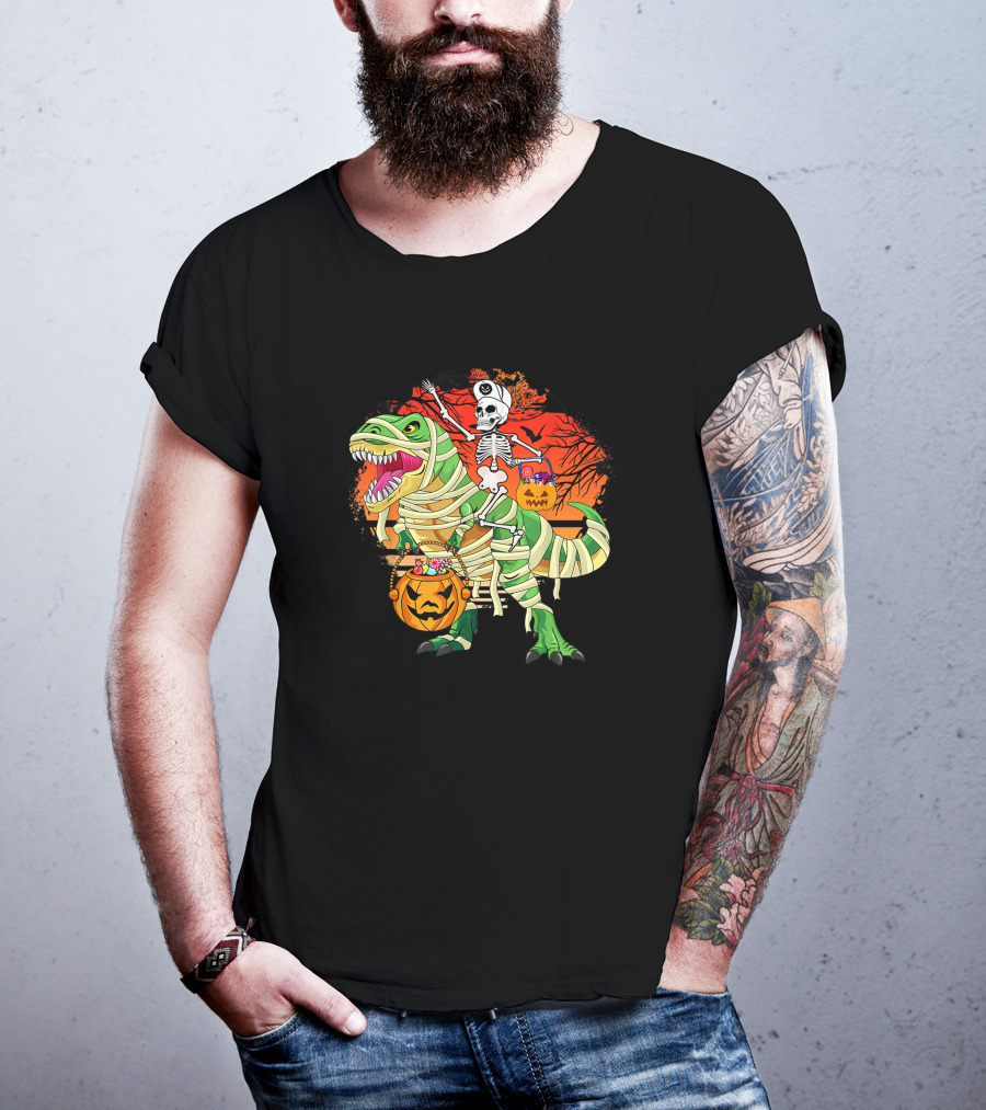 Skeleton Riding Mummy Dinosaur Rex With Halloween Pumpkins On Spooky Background T-Shirt