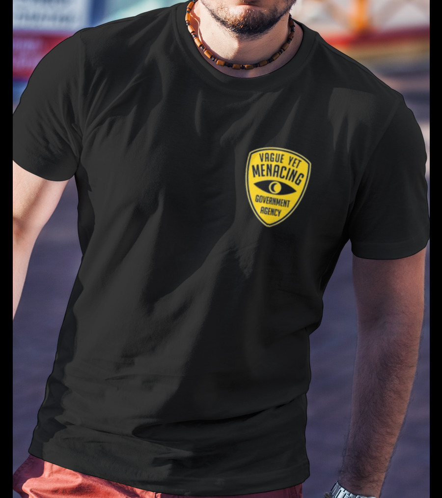 Vague Yet Menacing Government Agency Yellow Badge With Eye T-Shirt