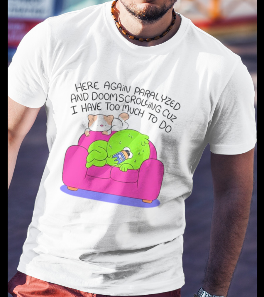 Here Again Paralyzed And Doomscrolling Cuz I Have Too Much To Do Quirky Green Figure Relaxing On Pink Couch With Cute Dog T-Shirt