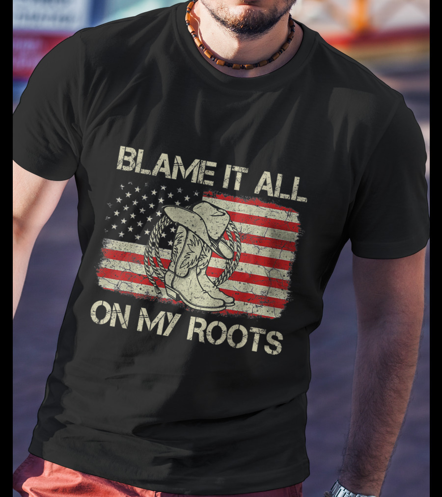 Blame It All On My Roots Cowboy Hat Boots American Flag Background T-Shirt