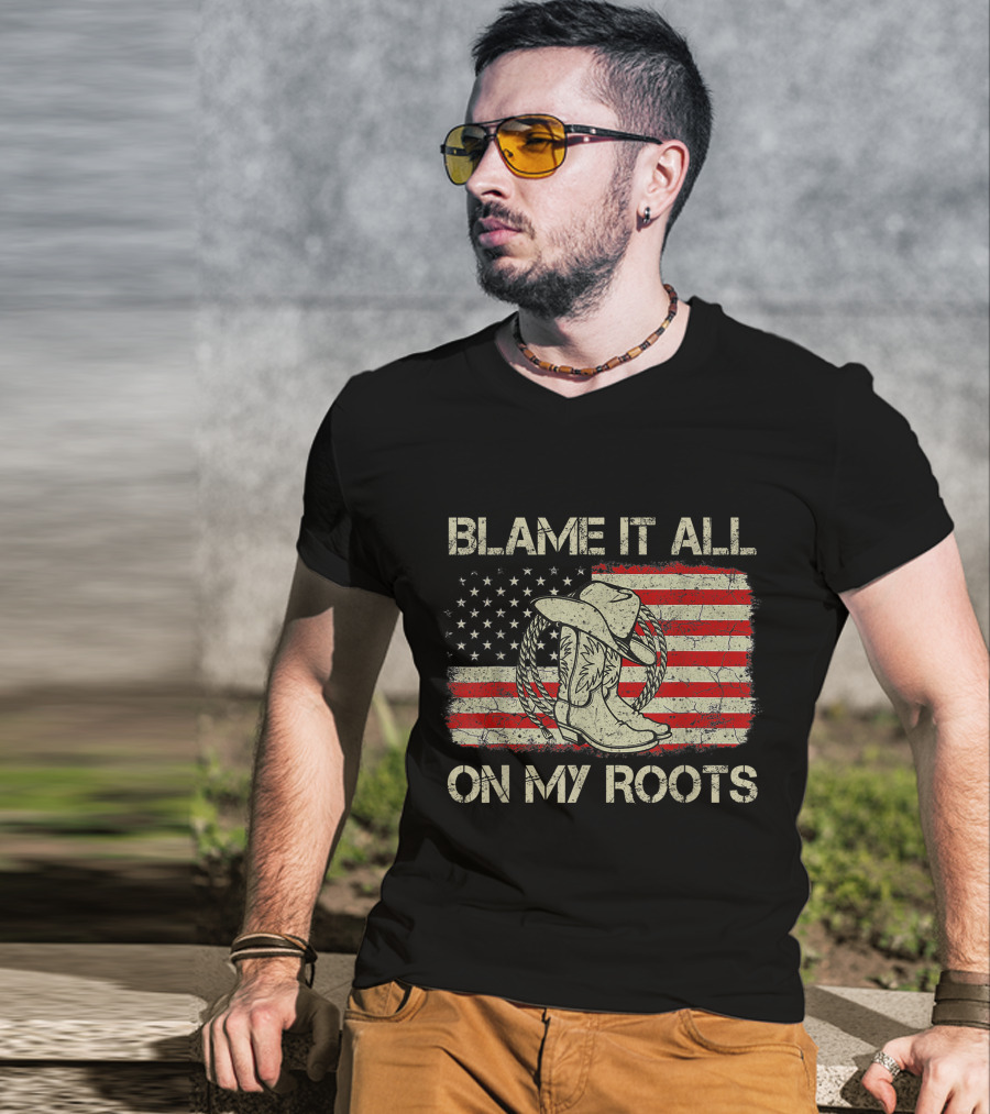 Blame It All On My Roots Cowboy Hat Boots American Flag Background T-Shirt
