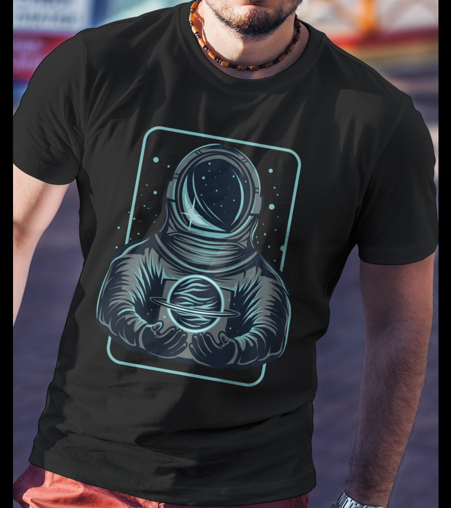 Astronaut Holding A Saturn-Like Planet In Space-Themed T-Shirt