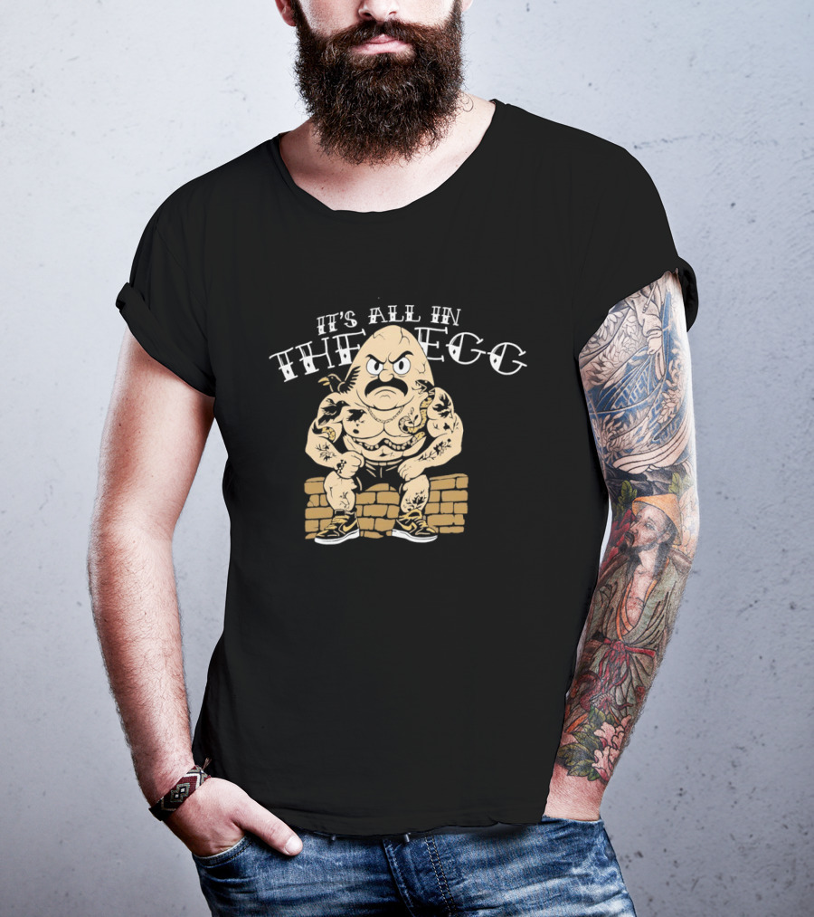 It's All In The Egg Muscular Cartoon Character With Mustache Sitting On Brick Wall T-Shirt