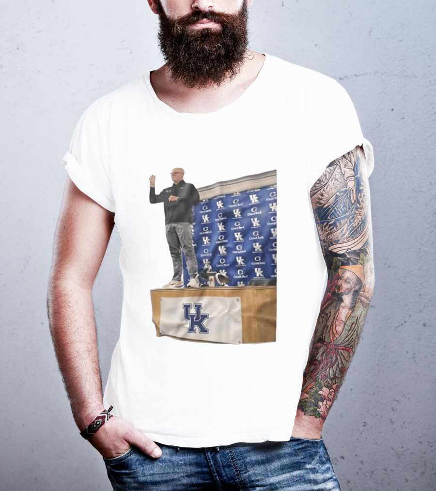 UK Volleyball Coach Craig Skinner Standing On Table With UK Logo And Awards T-Shirt