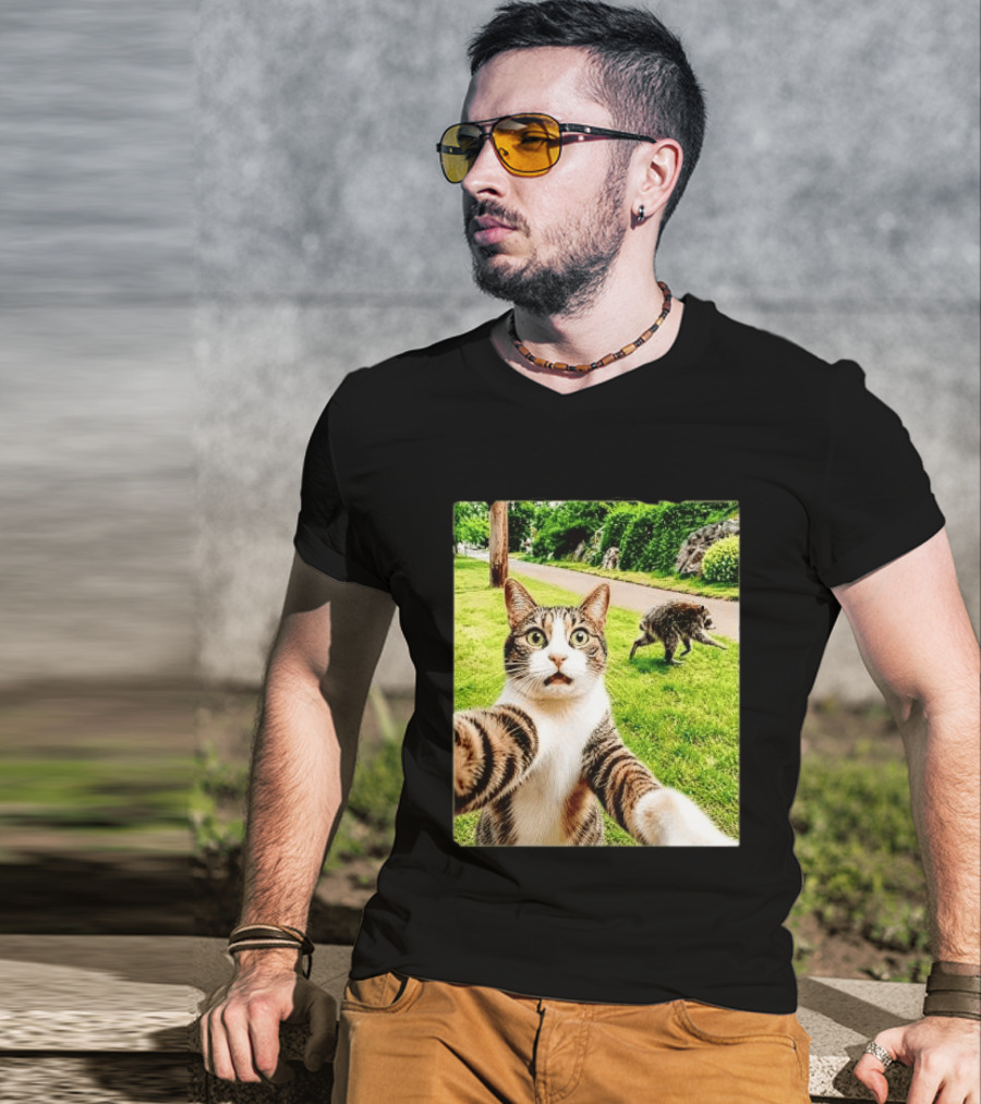 Shocked Face Tabby Cat Taking Selfie With Running Raccoon On Lawn Road T-Shirt