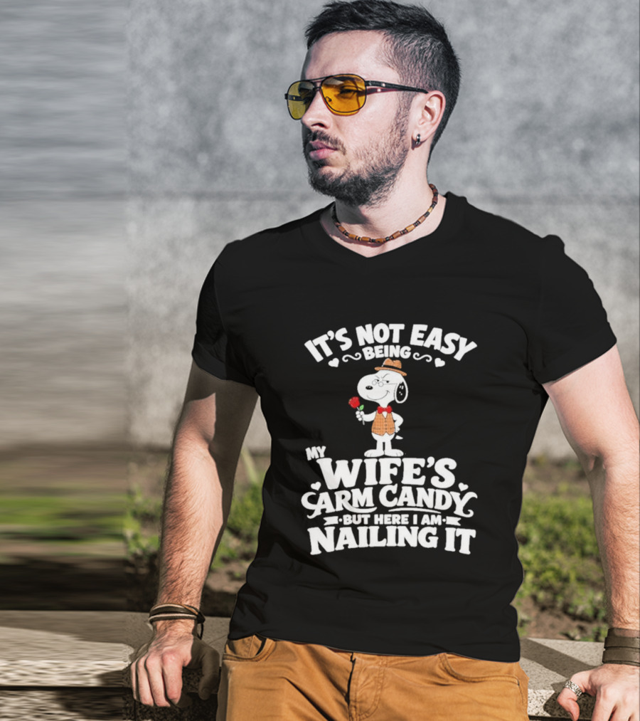 Snoopy It's Not Easy Being My Wife's Arm Candy But Here I Am Nailing It T-Shirt
