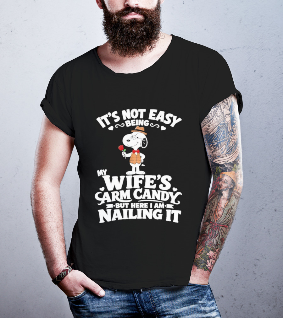 Snoopy It's Not Easy Being My Wife's Arm Candy But Here I Am Nailing It T-Shirt