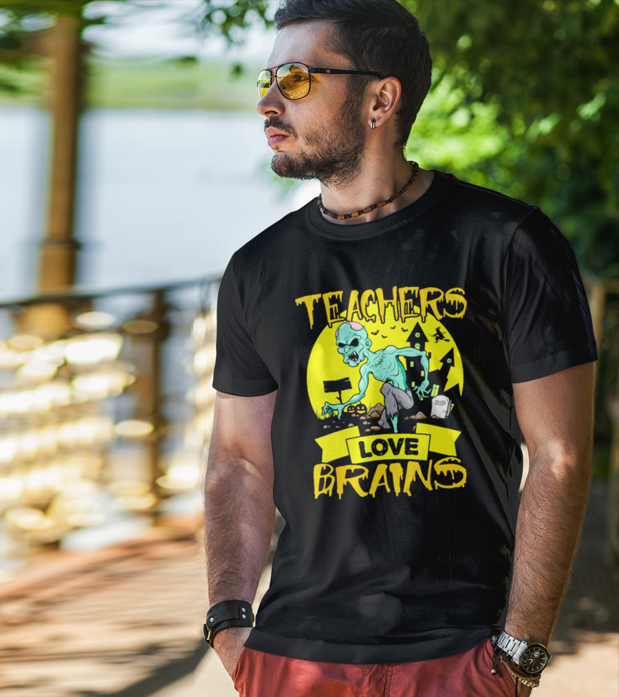 Teachers Love Brains Zombie Halloween Theme With Haunted Houses And Graveyard Background T-Shirt