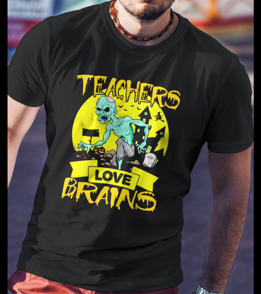 Teachers Love Brains Zombie Halloween Theme With Haunted Houses And Graveyard Background T-Shirt