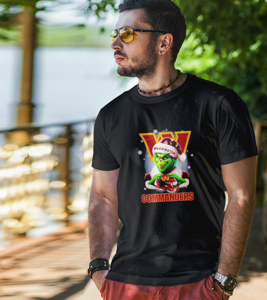 The Grinch Wearing Santa Hat Holding Gift For Washington Commanders Christmas T-Shirt