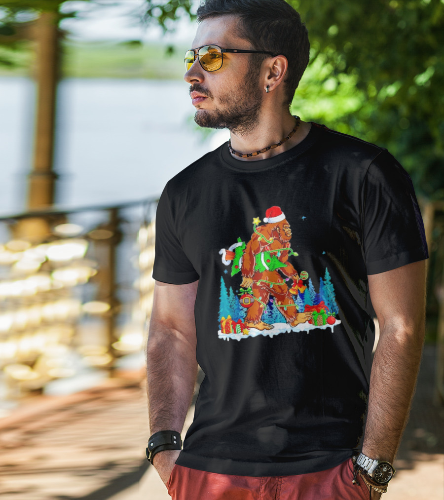 Bigfoot Santa Hugging Christmas Tree With Gifts And Snow Scene T-Shirt