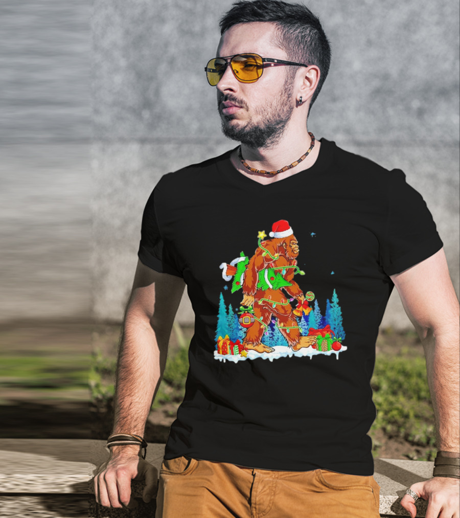 Bigfoot Santa Hugging Christmas Tree With Gifts And Snow Scene T-Shirt