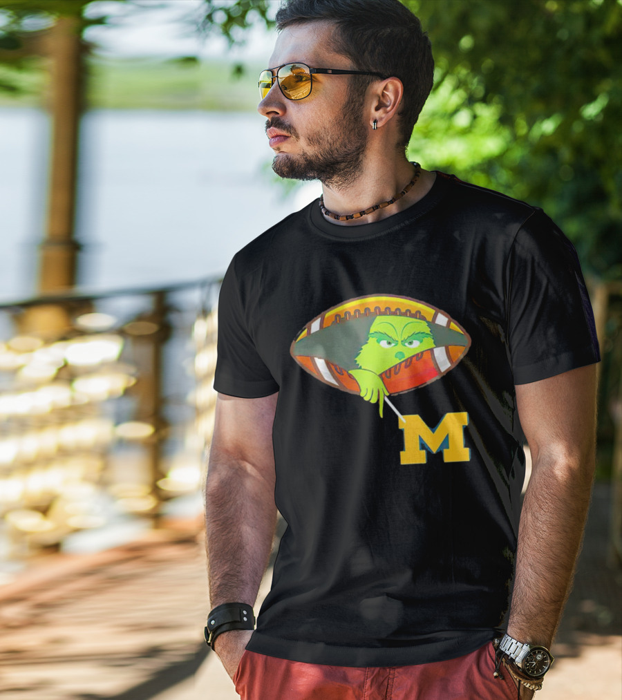 Grinch Peeking From Football Over Michigan Wolverines T-Shirt
