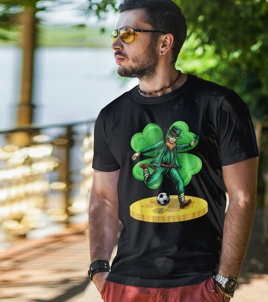 Leprechaun Kicking Soccer Ball On Gold Coin With Shamrock Background T-Shirt