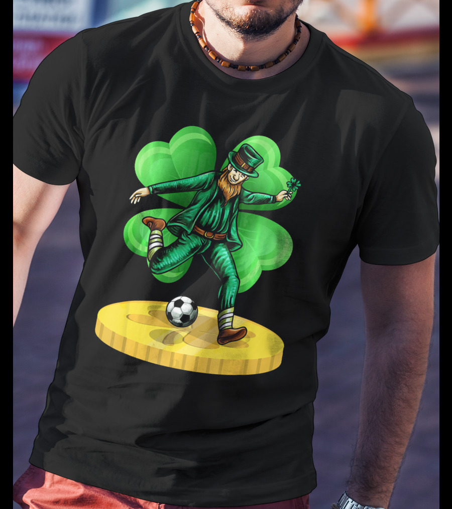 Leprechaun Kicking Soccer Ball On Gold Coin With Shamrock Background T-Shirt
