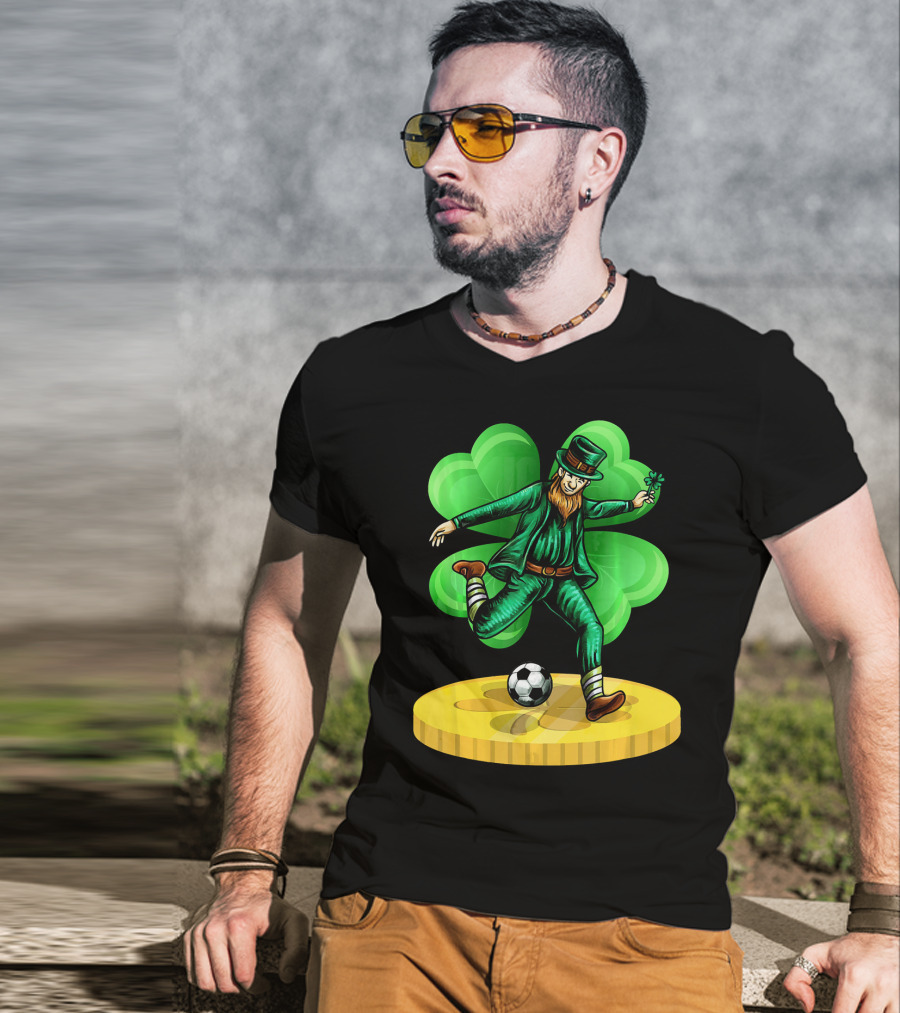Leprechaun Kicking Soccer Ball On Gold Coin With Shamrock Background T-Shirt