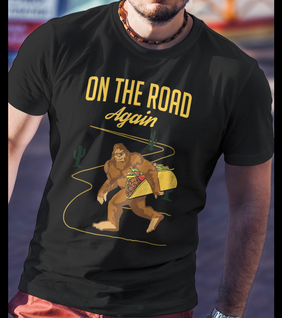 ON THE ROAD AGAIN Smirk Bigfoot Sasquatch Carrying Taco T-Shirt
