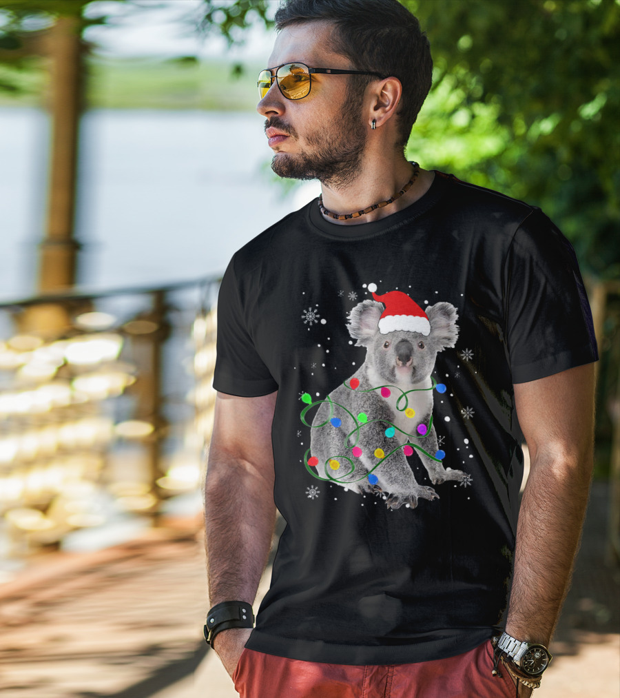 Koala Wrapped In Christmas Lights Wearing Santa Hat With Snowflakes Matching Fam T-Shirt