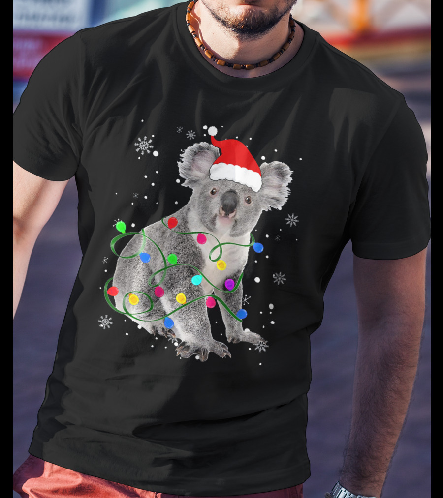 Koala Wrapped In Christmas Lights Wearing Santa Hat With Snowflakes Matching Fam T-Shirt