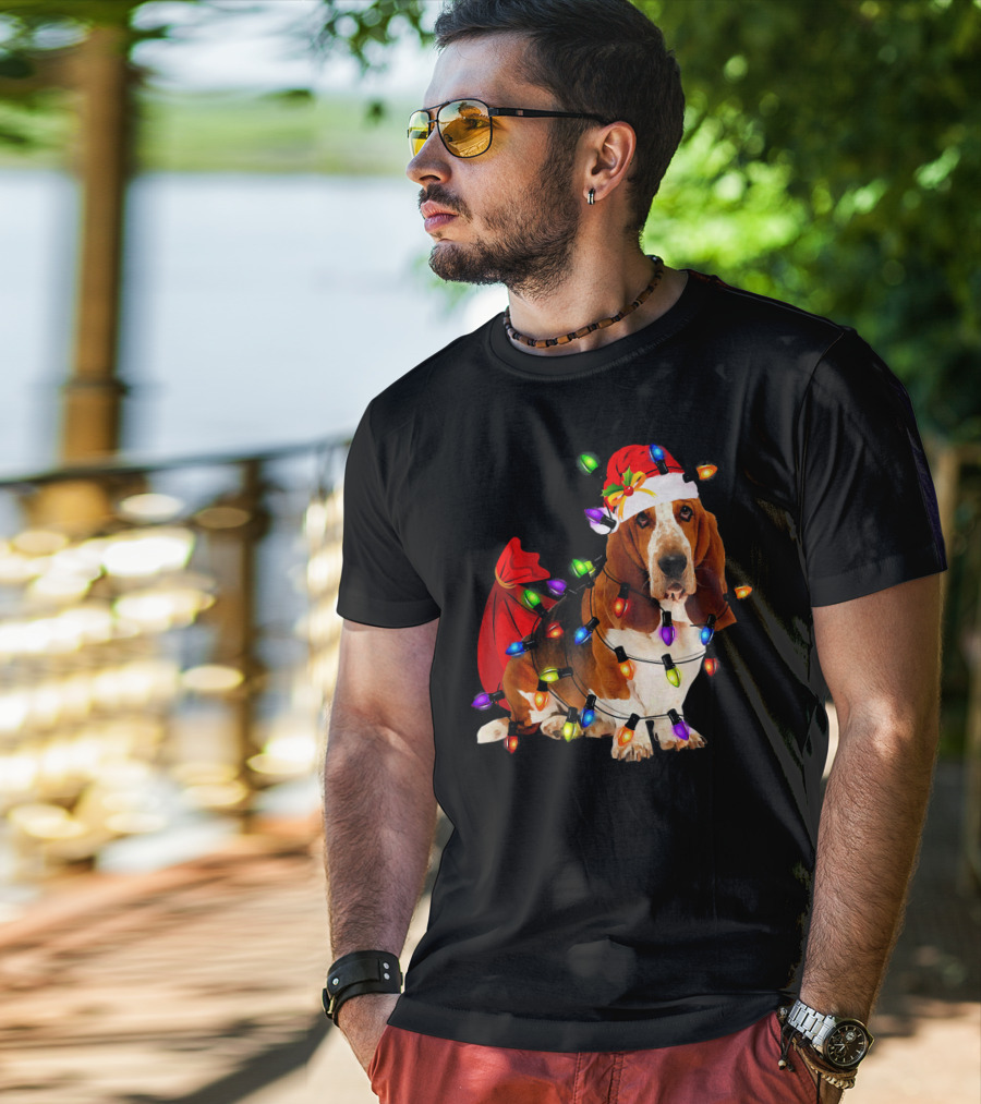 Basset Hound Wrapped In Christmas Lights With Santa Hat And Red Sack T-Shirt
