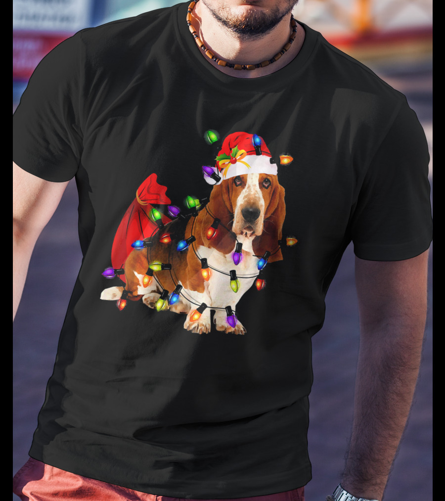 Basset Hound Wrapped In Christmas Lights With Santa Hat And Red Sack T-Shirt