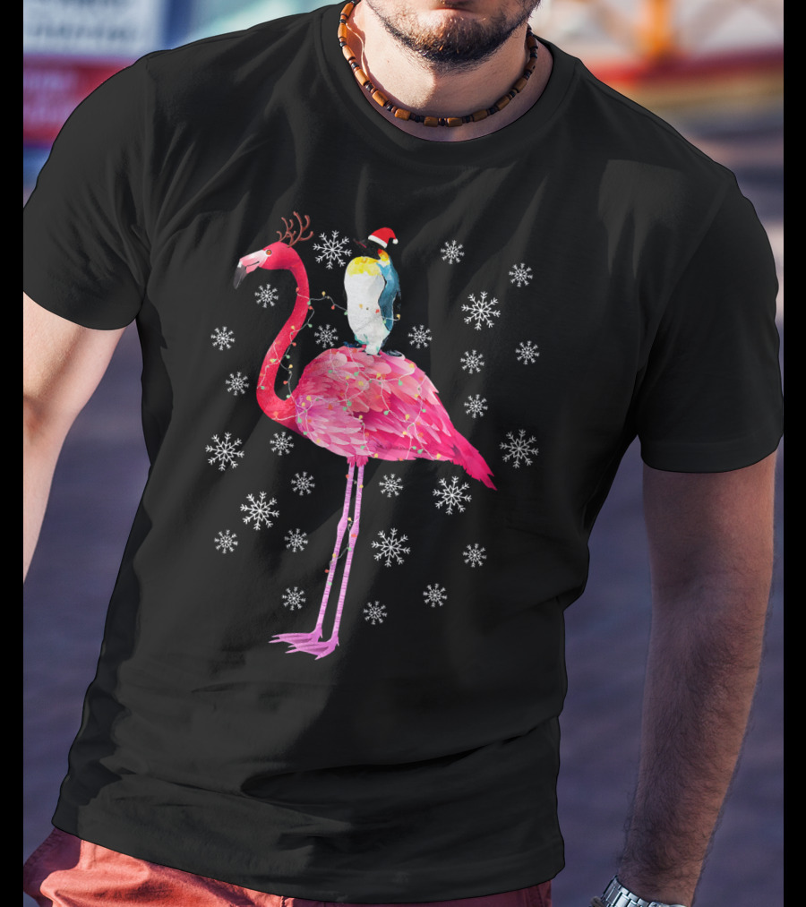 Penguin With Santa Hat Riding Flamingo With Antlers Surrounded By Snowflakes T-Shirt